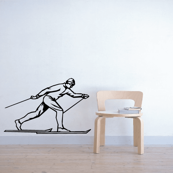 Skier wall decal, black line-art silhouette carving on skis