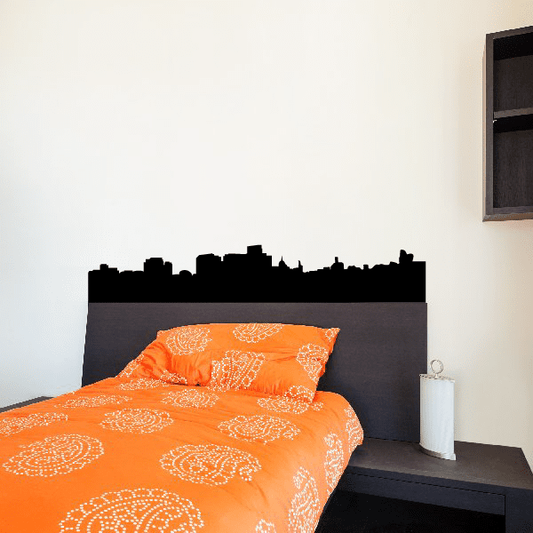 Black skyline cityscape wall decal silhouette above bed