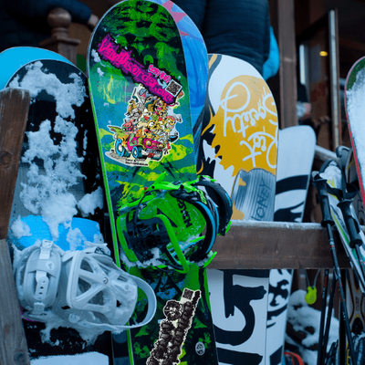 A collection of snowboarding-themed stickers displayed on a surface
