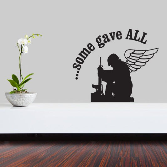 Black kneeling soldier wall decal with some gave all text and winged emblem.