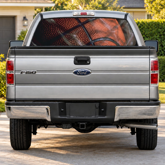Silver pickup truck rear view with basketball graphic decal on rear window