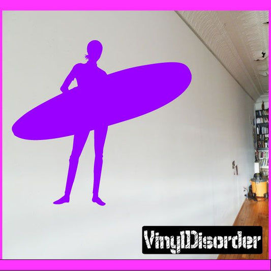 Purple surfing wall decal of a standing surfer on a waveboard silhouette