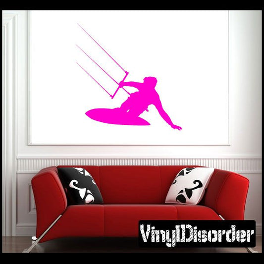 Pink surfing vinyl wall decal of a surfer on a board, bold silhouette