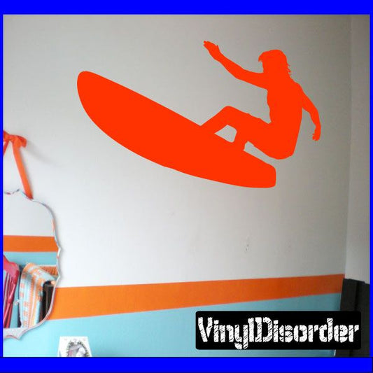 Surfing wall decal with orange surfer silhouette on surfboard