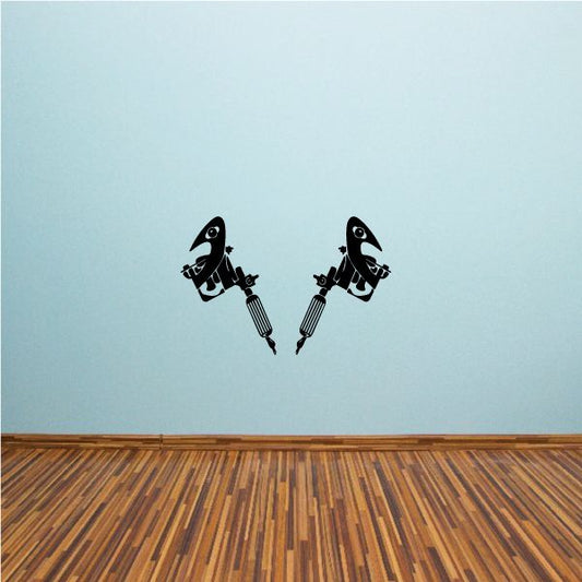 Tattoo gun vinyl decal showing two black tattoo guns with stylized text