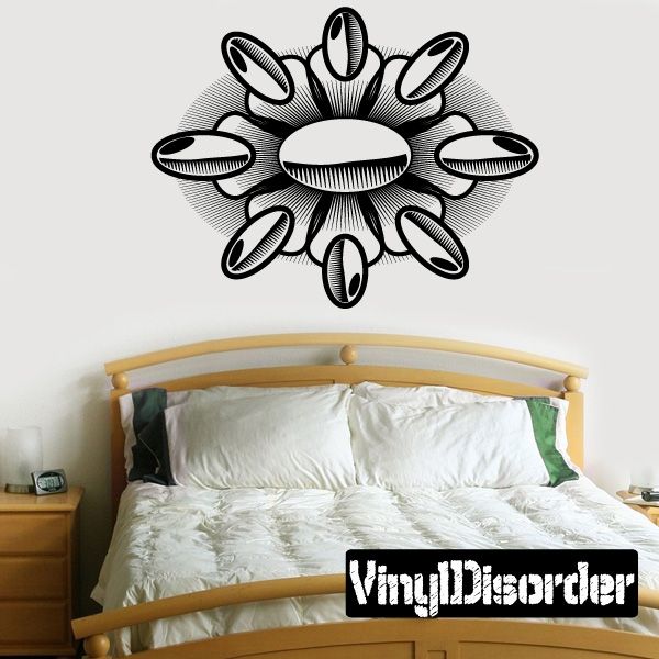 Black vinyl wall decal with tattoo-style burst flower design and oval center