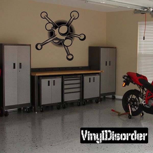 Black tattoo-style crossed tool wall decal with circular center