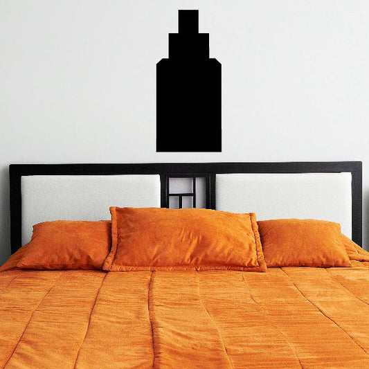 Three-tiered black wall decal, stacked rectangle design above bed