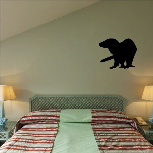 Black otter silhouette wall decal with small tail and paws
