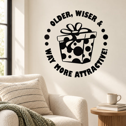 Black wall decal with gift box graphic and text: OLDER, WISER & WAY MORE ATTRACTIVE