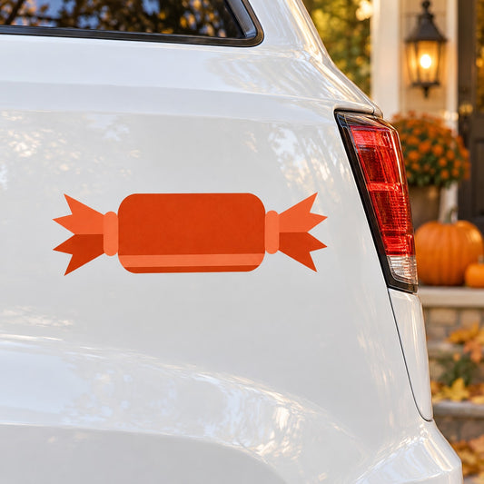 Orange candy-shaped Halloween decor sticker with banner and starburst ends on car