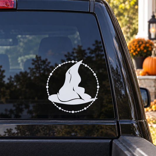 Beaded circle witch hat decal with white silhouette on a dark surface