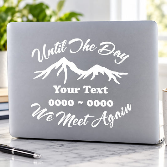 Gray laptop decal with white cursive “Until the Day…” and mountain graphic