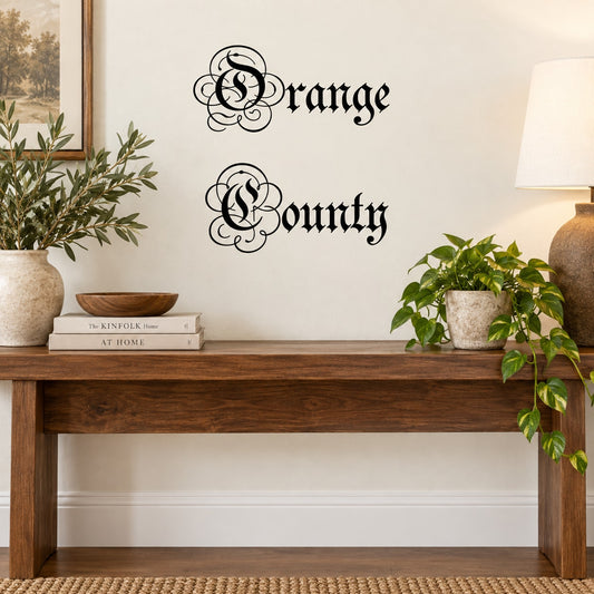 Ornate wall decal with black cursive 'Orange County' lettering