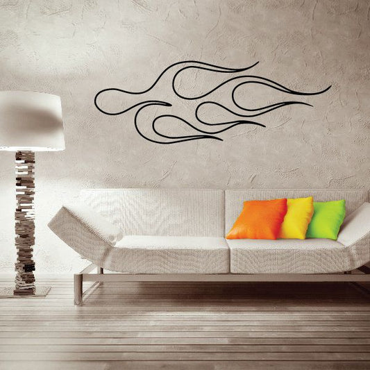 Vehicle pinstripe vinyl decal with black flame swirl lines on a wall