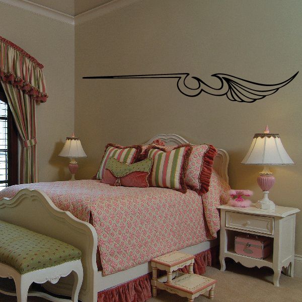Black vinyl pinstripe wing decal with curved scroll accents on wall