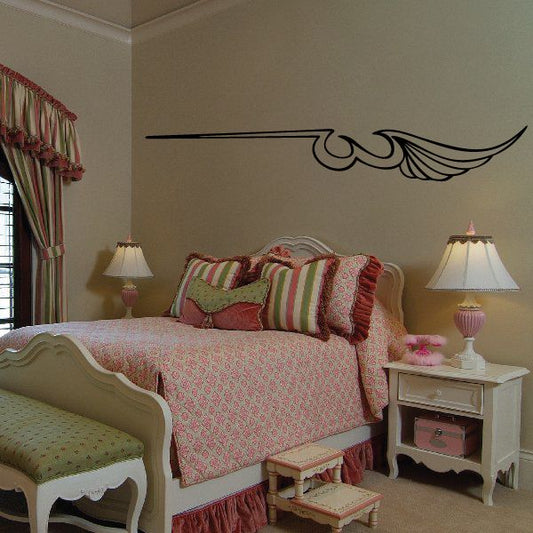 Black vinyl pinstripe wing decal with curved scroll accents on wall