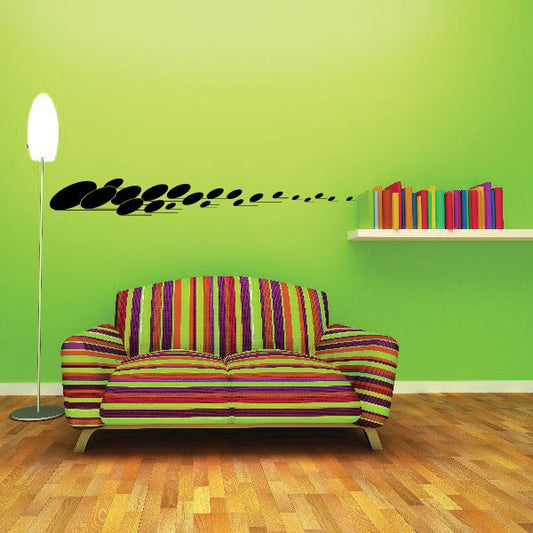 Vehicle pinstripe vinyl decal with black oval stripe shapes in a line