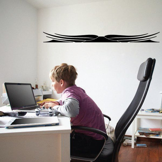 Black pinstripe vinyl decal with swooping double-line graphic on a flat surface
