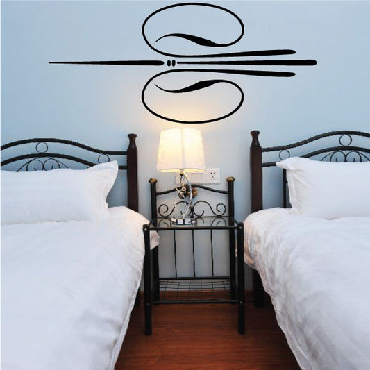 Vehicle pinstripe vinyl decal with black swoosh and swirl lines on wall.