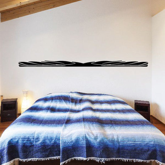 Black vehicle pinstripe vinyl decal with stacked racing stripes on a wall
