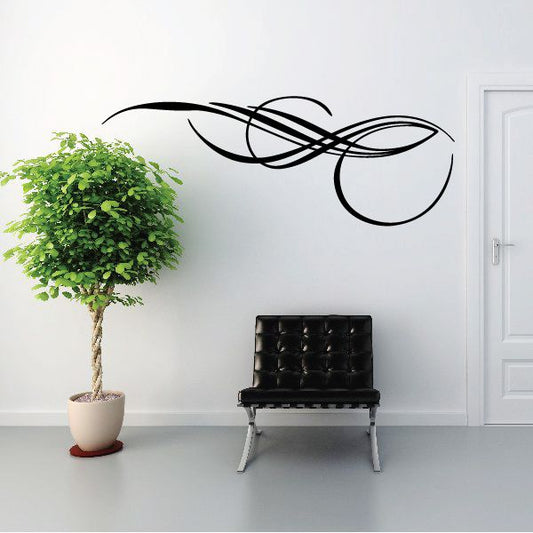 Black pinstripe vinyl vehicle decal with sweeping swirl lines on a wall