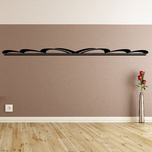 Pinstripe vinyl decal with black curved stripes on a smooth wall