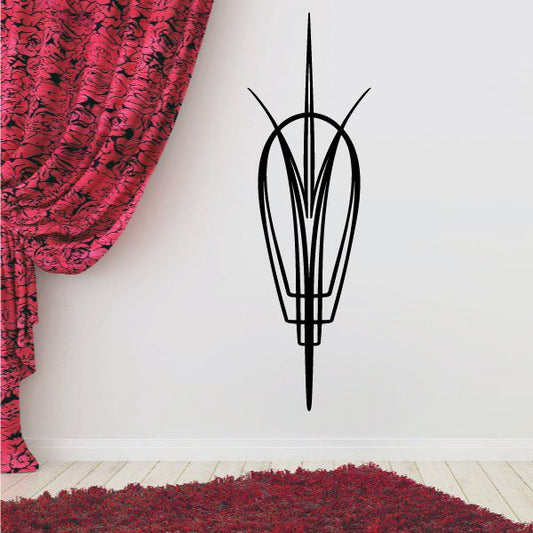 Black pinstripe vinyl decal of a vehicle emblem, tall outline on wall