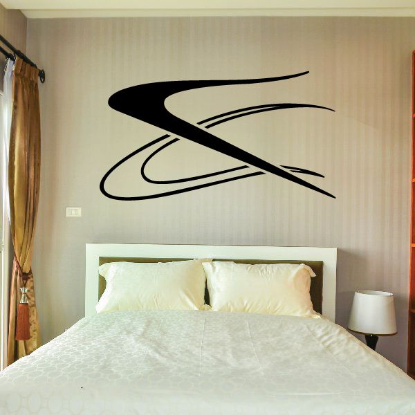 Vehicle pinstripe vinyl decal with sweeping black stripe design on a wall