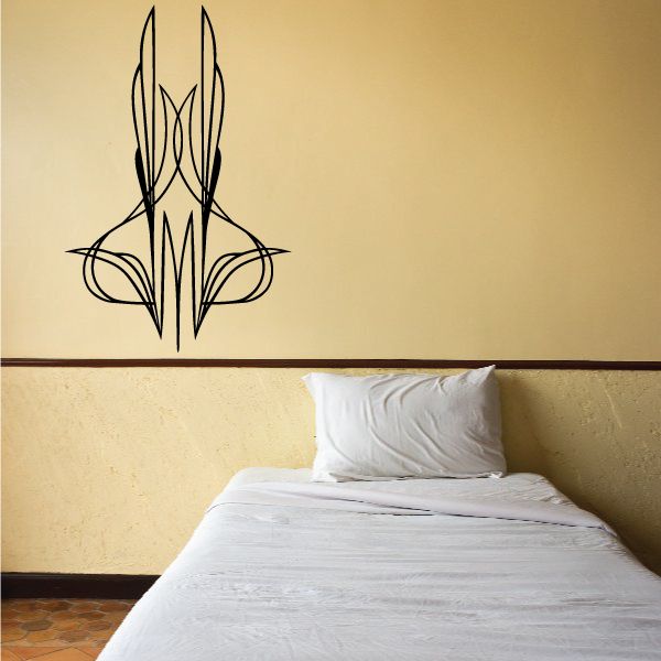 Black tribal pinstripe vinyl decal with winged vehicle emblem on wall