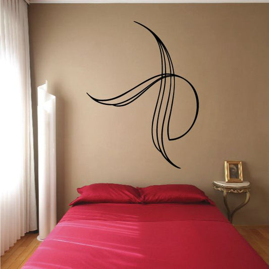 Vehicle pinstripe vinyl decal with flowing black swirl lines on wall
