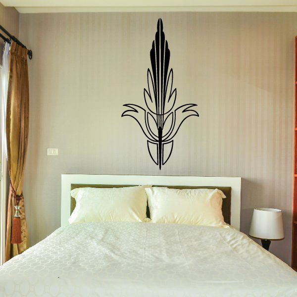 Black fleur-de-lis pinstripe vinyl wall decal above a bed