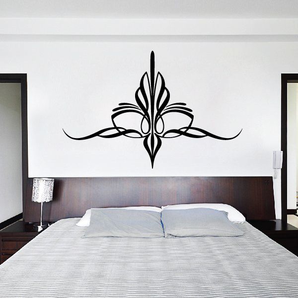 Ornate black vinyl wall decal with symmetrical floral scroll center