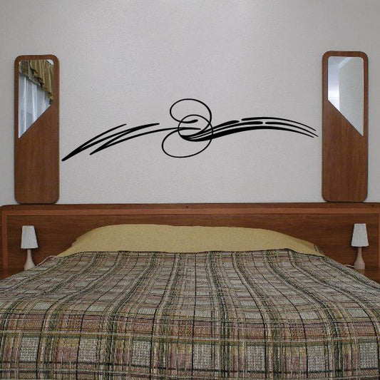 Vehicle pinstripe vinyl decal with swirling lines and two-ring emblem
