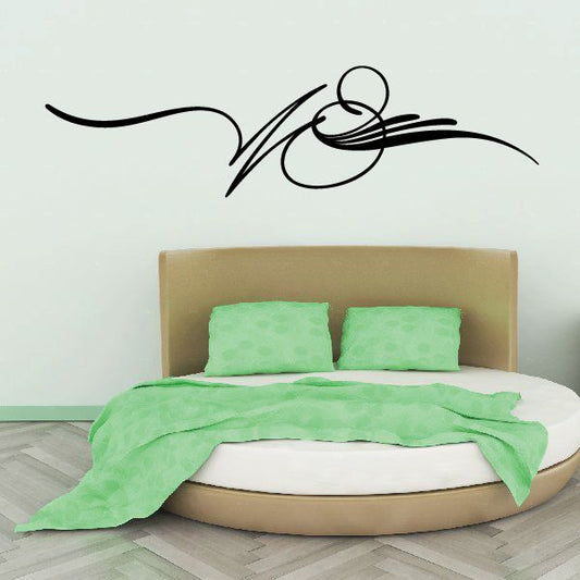 Black vehicle pinstripe vinyl decal with swooping flame-like lines on wall
