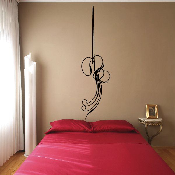 Black vinyl pinstripe decal with ornate swirl design on a vertical stem.