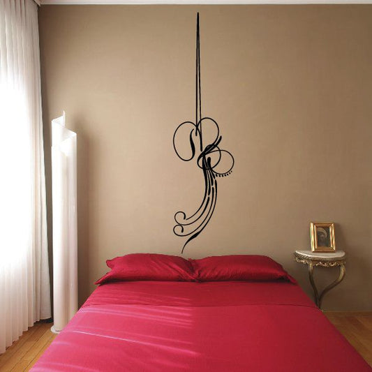 Black vinyl pinstripe decal with ornate swirl design on a vertical stem.