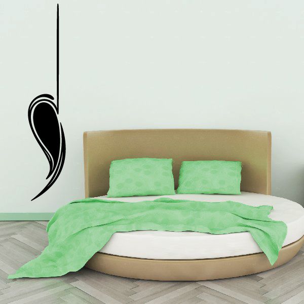 Vehicle pinstripe vinyl decal, black swoosh curl design on wall.