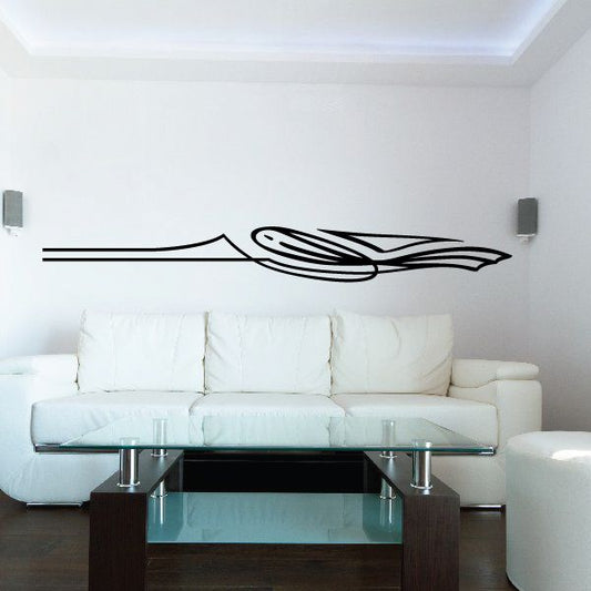 Black pinstripe vehicle vinyl decal with speed-line design on a wall