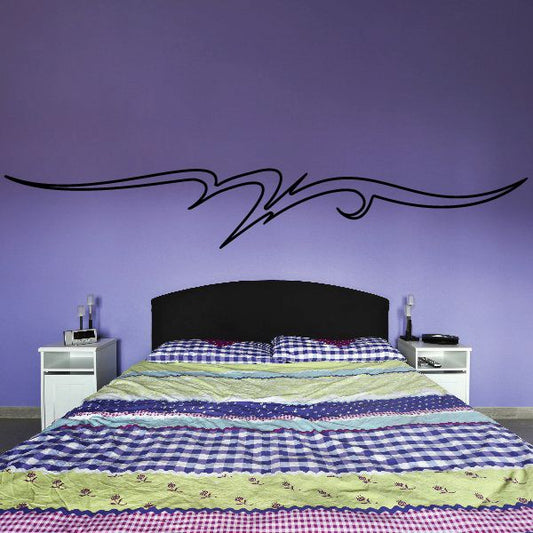 Black pinstripe vinyl wall decal with scroll swirls above bed headboard