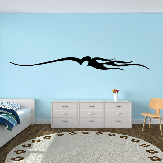 Black vehicle pinstripe vinyl decal with flame-style swoosh on wall