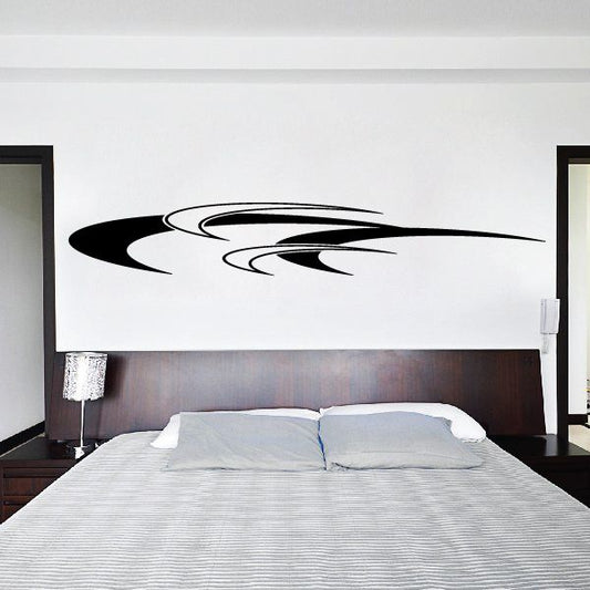 Vehicle pinstripe vinyl decal with black swoosh stripes on a wall