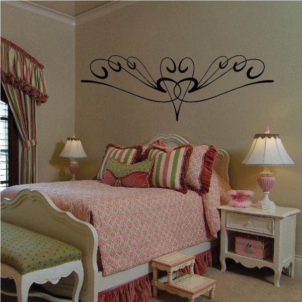 Ornamental black pinstripe vinyl decal with central heart and scrolling wings