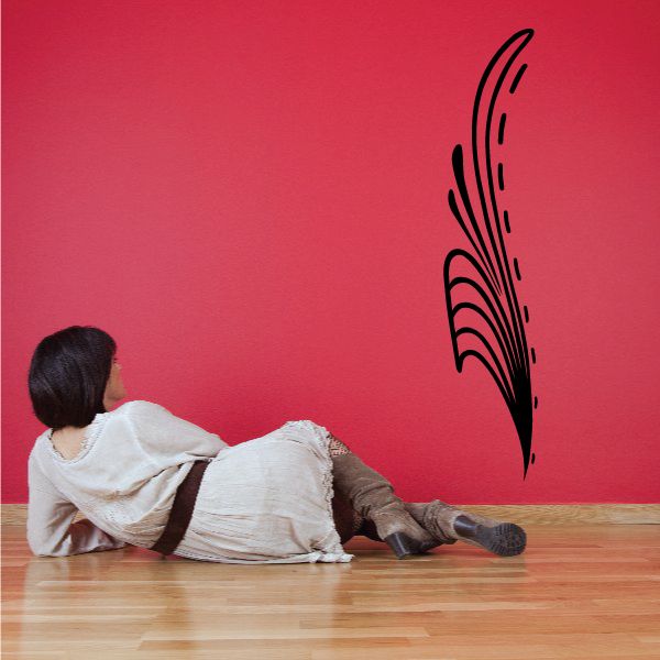 Vehicle pinstripe vinyl decal with black feather outline on red wall