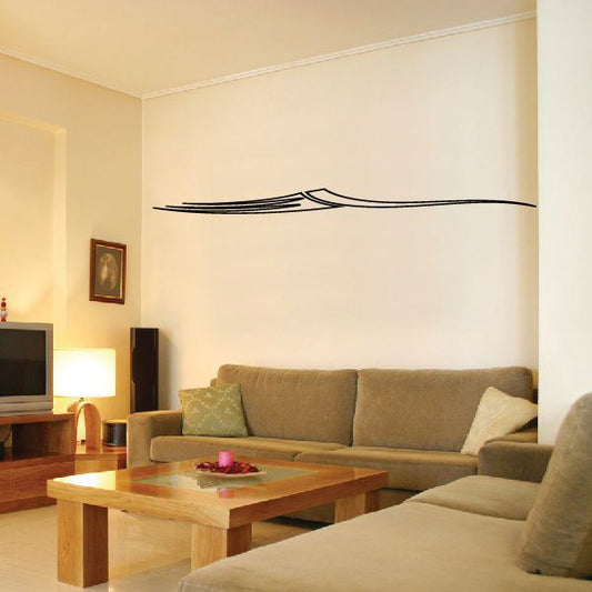 Black pinstripe vinyl decal with long curved stripe and arrow-like center on wall