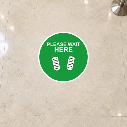 Green circular non-slip floor sticker: PLEASE WAIT HERE with footstep icons