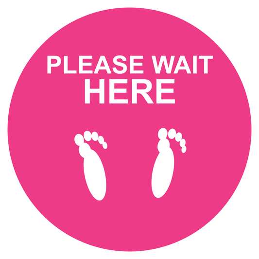 Pink circular non-slip floor sticker with “PLEASE WAIT HERE” text and footprints