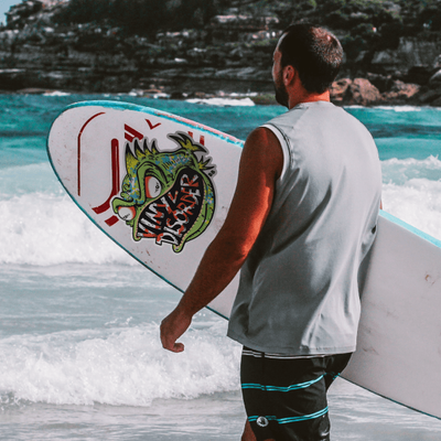 Person applying a waterproof sticker to a surfboard