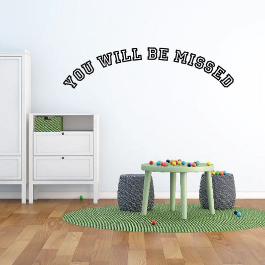 Wall vinyl decal with arched 'YOU WILL BE MISSED' lettering