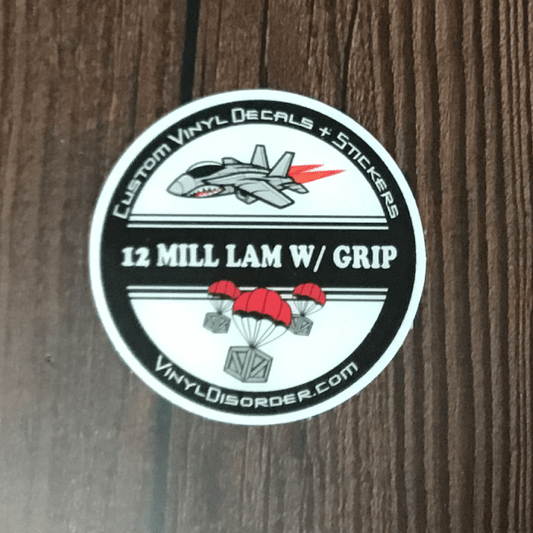 Round vinyl decal sticker with aircraft graphic and text "12 MILL LAM W/ GRIP"